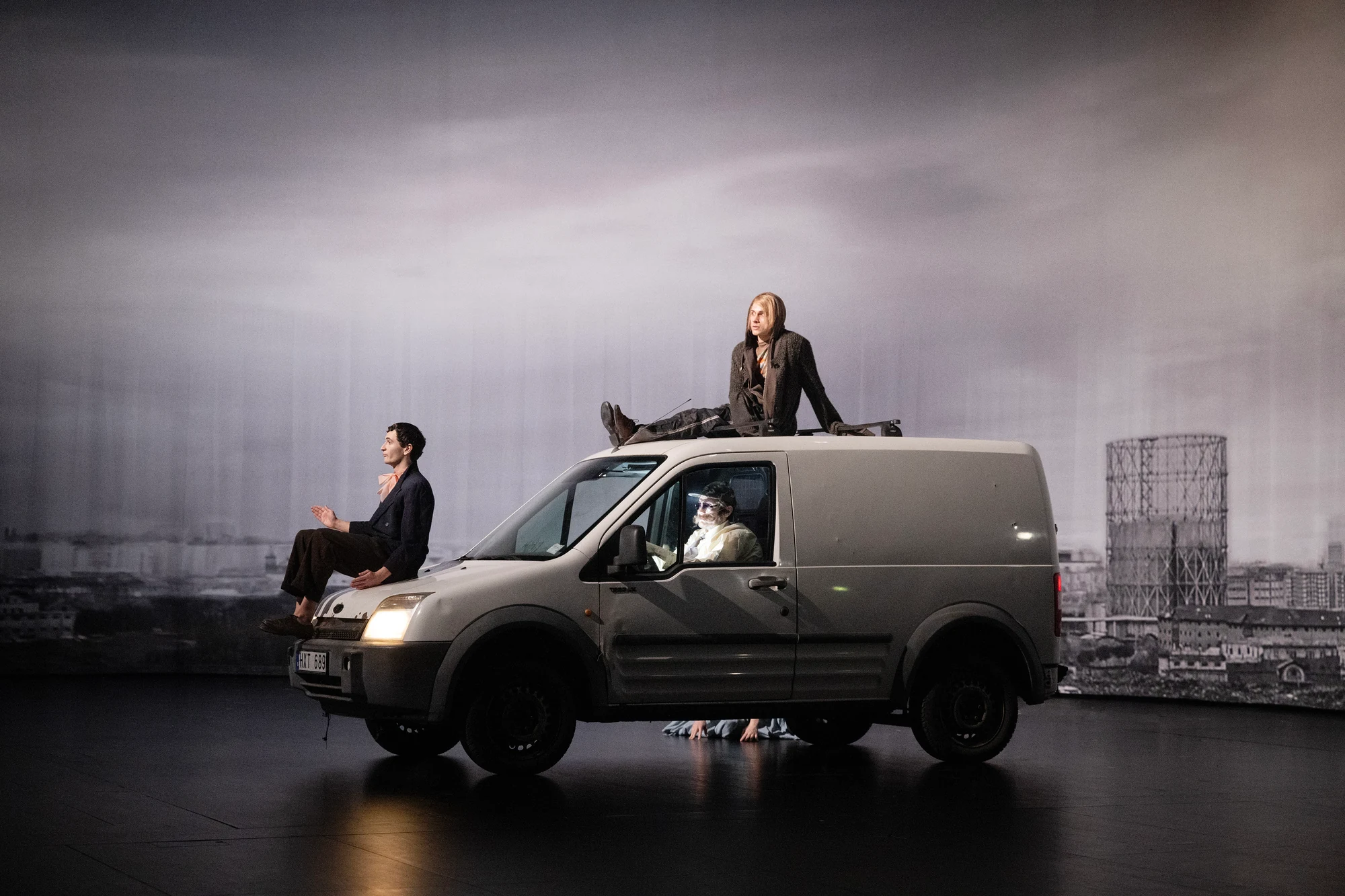 Pinocchio — ensemble performing around a van